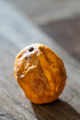 an old withered lemon on a wooden table