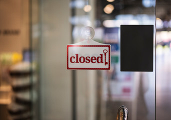  closed sign hanging outside a restaurant, store, office or other