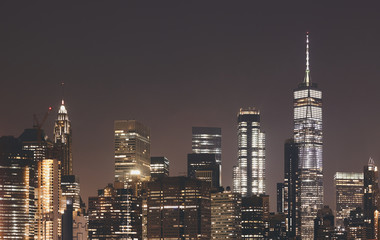 New York City skyline at night, color toning applied, USA.