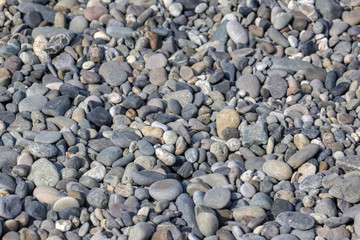 Stone pebbles on the seashore as an abstract background