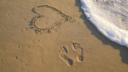 sand heart and footprints