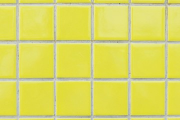 Yellow ceramic wall and floor tile abstract background.