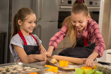 Two little girls sisters cooking together