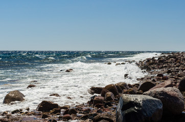 waves and splashes of sea surf and stones on the seashore in Egypt Dahab South Sinai