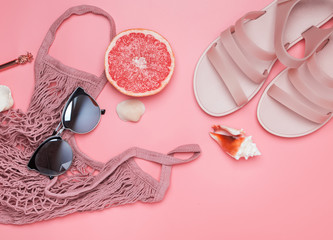 Stylish summer accessories on the pink background.