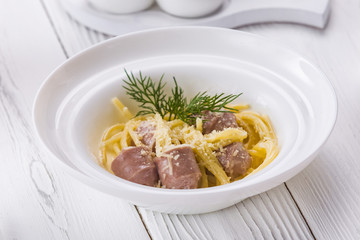An appetizer sausage with cheese in a bowl