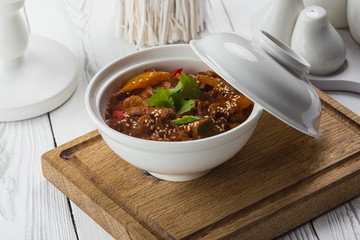 Spicy chicken with sesame seeds in a bowl
