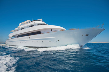 Luxury motor yacht sailing out on tropcial sea