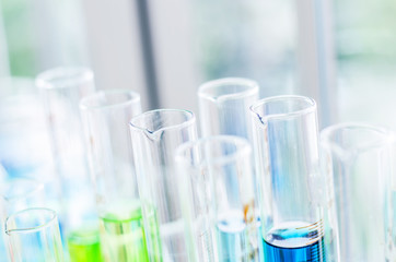 A pipette dropping sample into a test tube,abstract science background