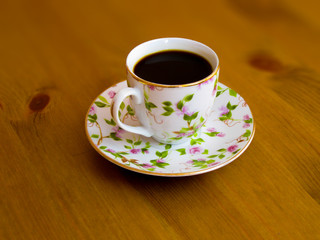 Porcelain cup with fragrant black coffee