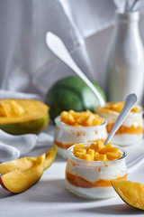 Mango yogurt on white backdrop.
