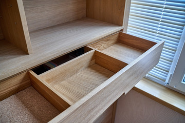Wooden cupboard with opened drawer. Modern furniture