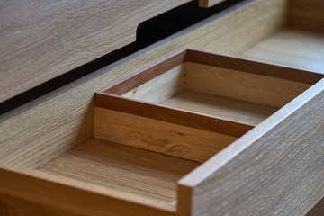 Wooden cupboard with opened drawer. Modern furniture
