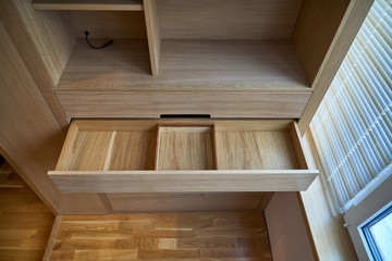 Wooden cupboard with opened drawer. Modern furniture