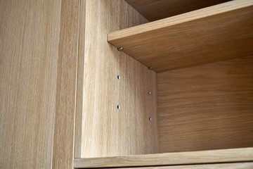 Naklejka na ściany i meble Wooden cupboard with drawers and empty shelves. Modern furniture
