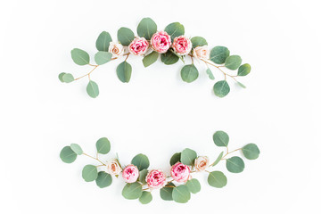 Wreath frame made of branches eucalyptus, pink ranunculus, roses and leaves isolated on white background. lay flat, top view
