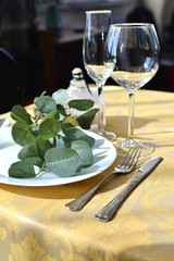 plate and cutlery on a yellow tablecloth, table setting