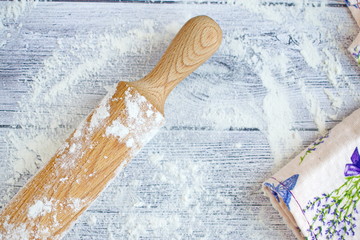wooden rolling pin on the boards with flour
