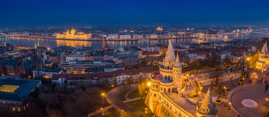 Budapest, Hungary - Aerial panoramic skyline view of Budapest with illuminated Fisherman's Bastion, Parliament of Hungary, Szechenyi Chain Bridge and St Stephen's Basilica at blue hour