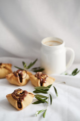 Chocolate pastry with cofee mug on white backdrop