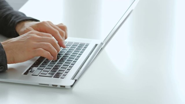 Data entry freelance job. Remote working and earning money online. Man hands typing on the laptop keyboard.