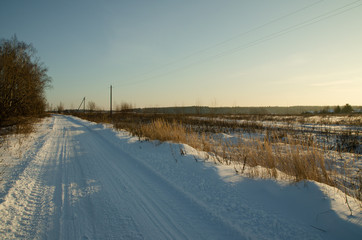 Fototapeta premium winter road on a frosty dawn morning