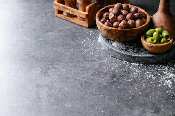Green olives in wooden bowl