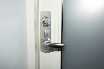 Close up view of lock on white door. Interior design. Beautiful backkgrounds.