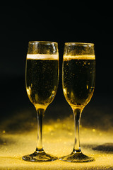 glasses of champagne on black background
