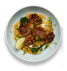 A bowl of succulent  Harissa Meat Balls on a bed of cuscus