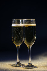 glasses of champagne on black background