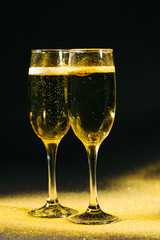 glasses of champagne on black background