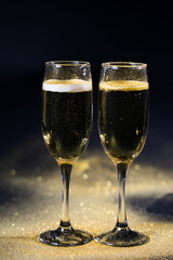 glasses of champagne on black background