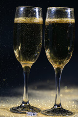 glasses of champagne on black background