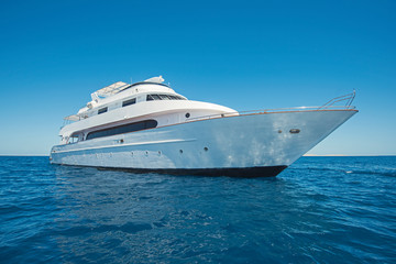 Luxury motor yacht sailing out on tropcial sea
