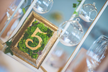 wedding table with floral arrangement prepared for reception, wedding, birthday or event centerpiece 