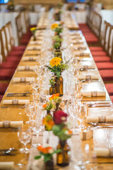 wedding table with floral arrangement prepared for reception, wedding, birthday or event centerpiece 