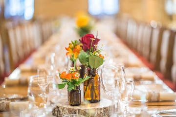 wedding table with floral arrangement prepared for reception, wedding, birthday or event centerpiece 
