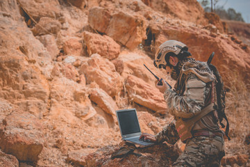 Soldiers of special forces on wars at the desert,Thailand people,Army soldier use laptop for see...