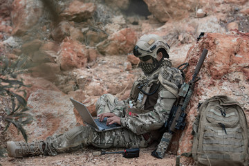 Soldiers of special forces on wars at the desert,Thailand people,Army soldier use laptop for see map with satellite,Using Radio For Communication During Military Operation