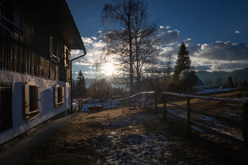 scenic view in alpine forest mountains with isolated wooden chalet house in idyllic sunny winter environment, pokljuka, slovenia	