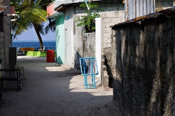 Fototapeta na wymiar A blue seat on a typical maldivian street (Ari Atoll, Maldives)