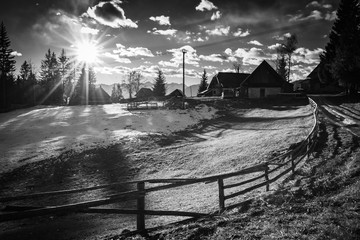 scenic countryside wooden chalet in julian alps mountains in black and white, uskovnica, slovenia	