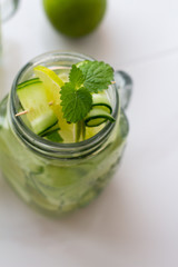 water with mint, lime and cucumber close up.