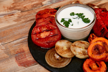 Grilled vegetables on black background. Diet vegan food.