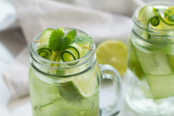 glasses with a refreshing drink, mint, lime and cucumber close-up.