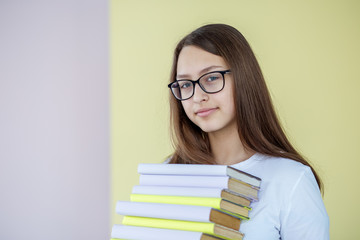 Girl in glasses with books. Concept of education, hobby, study and world