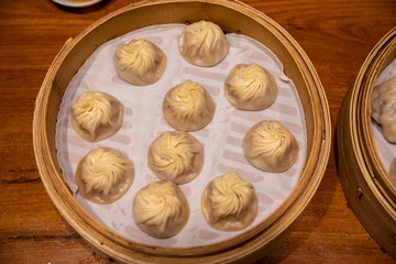Chinese steamed steamed bun ( baozi ) named Xiaolongbao also called a soup dumpling. It is traditionally prepared in xiolong small bamboo steaming basket. Michelin star awarded Din Tai Fung restaurant