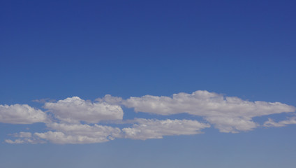 Curly clouds on clear sky