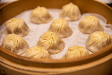 Chinese steamed steamed bun ( baozi ) named Xiaolongbao also called a soup dumpling. It is traditionally prepared in xiolong small bamboo steaming basket. Michelin star awarded Din Tai Fung restaurant